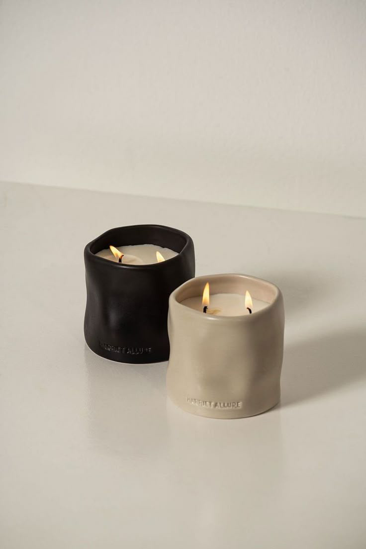 Hand-poured scented candles in black and cream hand-formed vessels